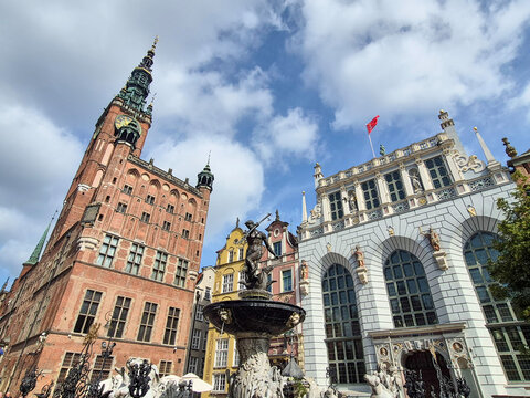 The Bronze Neptune Fountain and the Gothic Main City Hall Tower in the Historic Old Town District of Gdansk, Poland