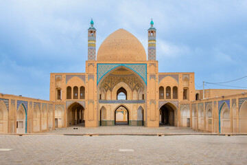 Wonderful view of Agha Bozorg Mosque on blue sky background in Kashan, Iran. The historical mosque and madrasa is a popular tourist attraction of the Middle East.