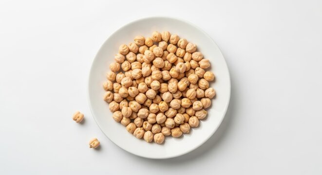 Chickpeas on a white plate on a plain white background