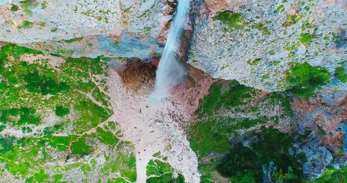 Aerial view of Rinka waterfall in alpine valley