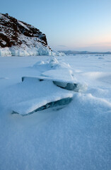 Ice Pressure Ridge Across Frozen Lake at Sunrise After Fresh Snowfall. Dramatic Winter Landscape Background © Olga Lyubochkina