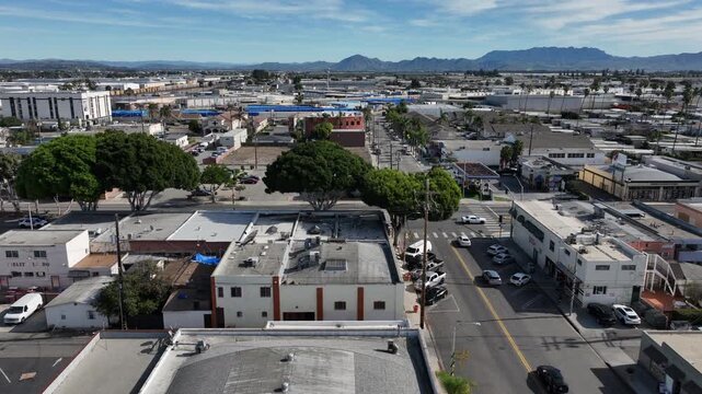 Oxnard, California, USA &ndash; High Aerial View of Urban Neighborhood and Residential Streets With City Skyline, Tree-Lined Roads, and the Topatopa Mountains in the Background on a Clear Day
