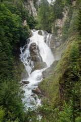 Majestic Waterfall Cascade Through Lush Green Mountain Forest Landscape