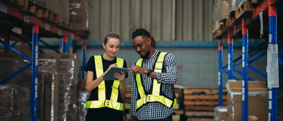 Warehouse worker working and checking the stock in the warehouse. Factory manager using digital tablet check barcode in industry factory logistic.