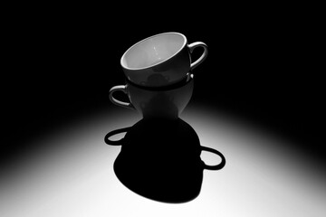 Black coffee cup lighted with opposite light source