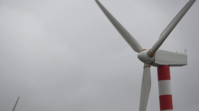 Modern wind turbine in operation on a cloudy day
