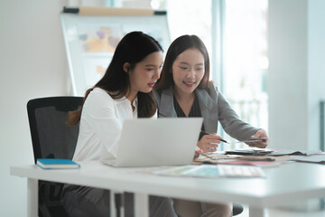 Obraz premium Two people working together on interior design project using documents and samples at office workspace