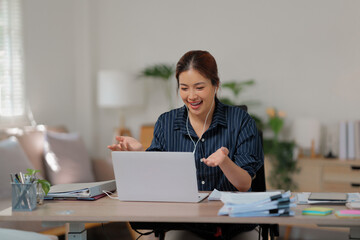 Fototapeta premium Happy asian woman speak conference on laptop&nbsp;in video call people smart working from home