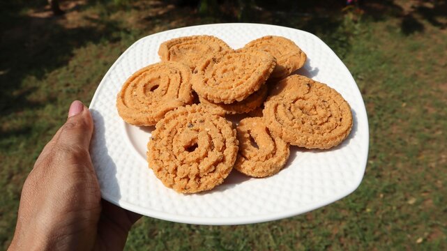 Crunchy and crumbly butter murukku or chakli. Chakri made of rice flour served in plate as tea time snacks