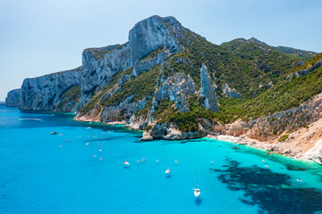 Fototapeta premium Aerial view of Cala Goloritzè, iconic turquoise bay with white limestone cliffs and crystal clear water on the Baunei Coast, Sardinia, Italy