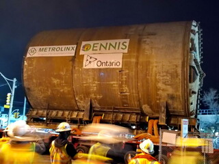 Fototapeta premium Toronto, Ontario, Canada, April 18, 2015: A tunnel boring machine is extracted west of Allen Road and moved on a massive trailer to be re-inserted east to bypass the TTC's Line 1 subway. This boring m