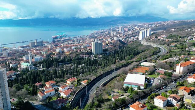 Rijeka's dynamic coastal charm from above. Port activity, urban life, and the serene Kvarner Bay under a dramatic sky. Croatia's vibrant Adriatic gateway.