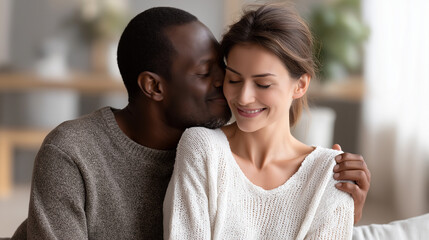 Fototapeta premium Couple sharing loving moment at home with warm embrace, living room affection, interracial relationship happiness, indoor togetherness celebration, domestic intimacy, with copy spa