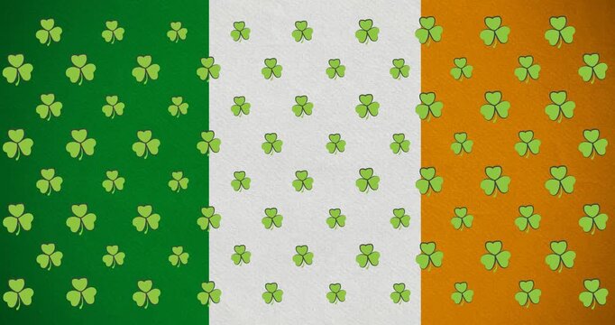 Digital animation of multiple clover leaves moving against irish flag