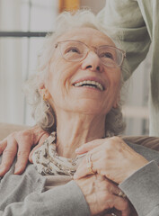 Comforting hand on shoulder of elderly person