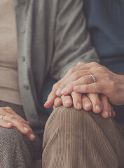 Elderly couple holding hands and supporting each other