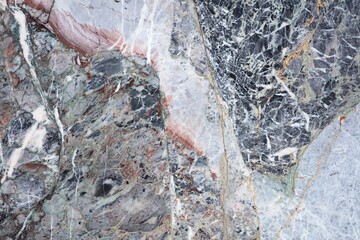 Unique patterns in colorful marble showcase nature's artistry at a stone quarry in the afternoon light