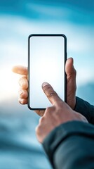 Person using smartphone to interact with blank screen outdoors in natural setting, technology lifestyle concept, hand holding phone with touch gesture in tranquil environment