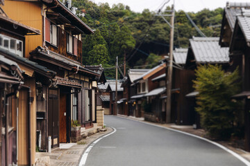 Obraz premium Ine Fishing Village, Kyoto prefecture, Japan, Ine-ura landscape coastal view, Funaya, traditional wooden boat houses, Ine Bay during boat tour cruise, Yoza District, in a autumn fall day