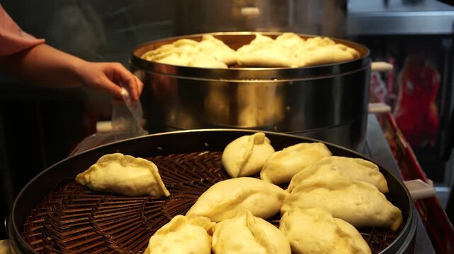 Traditional Chinese Dumplings Steaming in Bamboo Baskets at Market