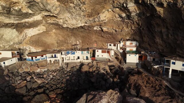 Aerial drone footage of houses built into cliffs in Por&iacute;s de Candelaria, La Palma, Canary Islands
