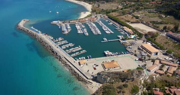 Aerial view of the Tropea marina, located in the province of Vibo Valentia, Calabria, Italy. It is a small port and a summer tourist destination overlooking the Mediterranean Sea.