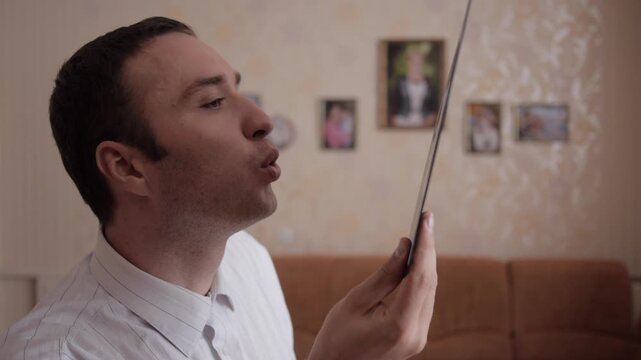 Man Blows Dust Off Vinyl Record