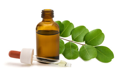 Senna branch with glass bottle and dropper isolated on white