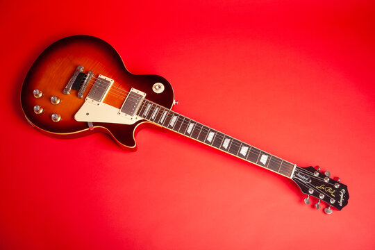 epiphone les paul standart electric guitar on red background