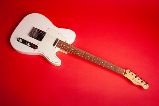 white fender telecaster electric guitar on red background