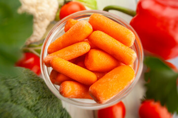 baby carrots on wood background top view