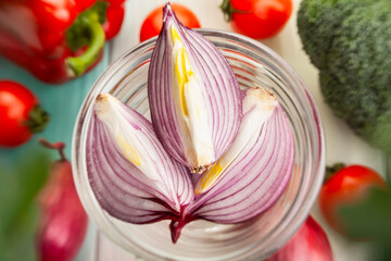 sliced red onion on wood background