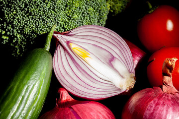 sliced red onion vegetable mix on black background