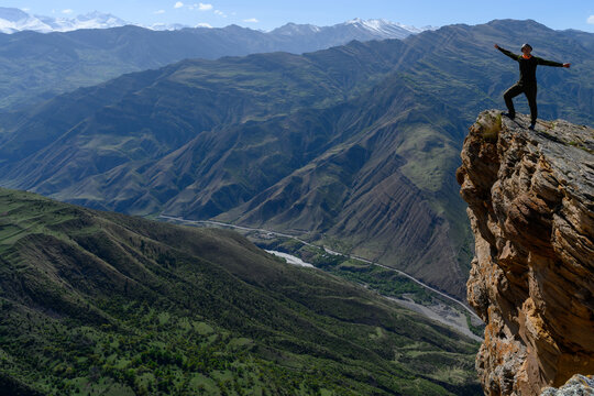 Person Standing on Cliff with Mountain View. Goor, Dagestan, Russia.