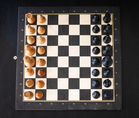 chess pieces on a chessboard on a dark background