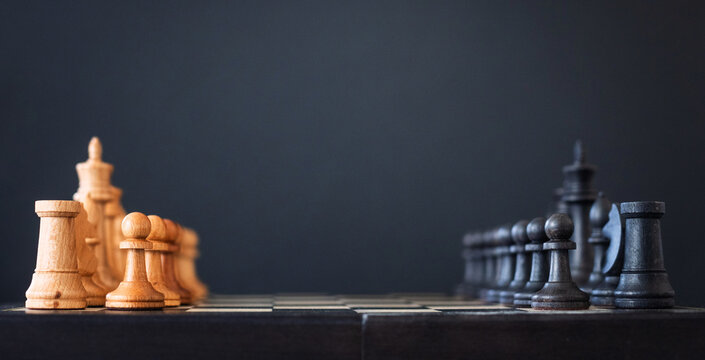 chess pieces on a chessboard on a dark background