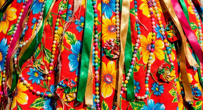 Detailed Texture of Colorful Traditional Brazilian Folklore Costume with Floral Fabric, Satin Ribbons and Beads