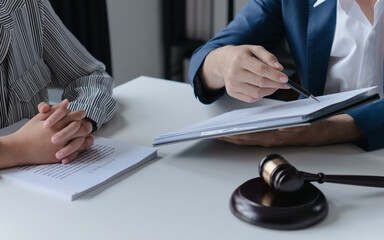 Attorney consulting clients in law firm office with professional discussion