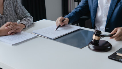 Attorney consulting clients in law firm office with professional discussion