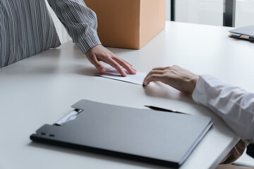 Business people giving a resign letter to quit a job at office