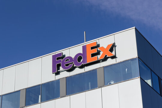 Close-up of the FedEx corporate logo on a modern office building exterior against a clear blue sky in the Hoofddorp business district. Hoofddorp, Netherlands. 8 February 2026.