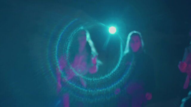 Group of millennials dancing on roller skates in dark studio. Teenagers spending time together freeskating and showing moves, having good time. View on nightlife youth culture. Concept of lifestyle.