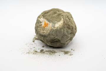 Spoiled orange covered with mold isolated on white background. Rotten citrus fruit with visible decay, fungal contamination and organic food waste concept.