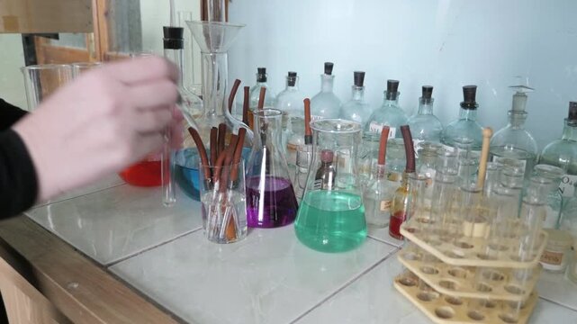 Female Student Or Teacher Doing Chemical Experiment In The Laboratory 