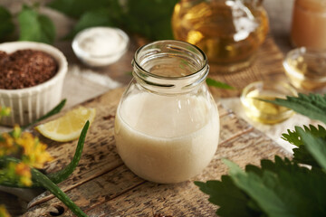 A jar of DIY shampoo made with homemade flax seed gel, argan oil, apple cider vinegar, nettle and coco glucoside