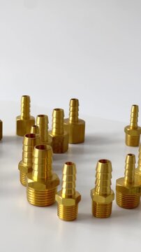 Comprehensive assortment of brass and steel pneumatic fittings, including hose barbs, quick couplers, and T-shaped connectors, professional industrial hardware collection for fluid engineering isolate