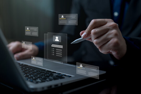 Human resource evaluation concept with digital employee profiles and rating cards above laptop, showing performance assessment, candidate review, talent management and data driven HR decision making.