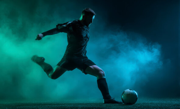 Football player running with ball through smoke and light effects showing strength and athletic performance