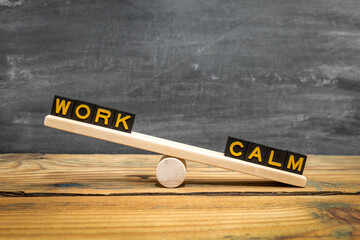 WORK CALM Balance Concept Displayed On Wooden Seesaw With Letter Blocks