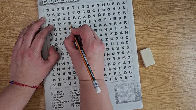 Person answering a word search puzzle, a brian game, aerial view